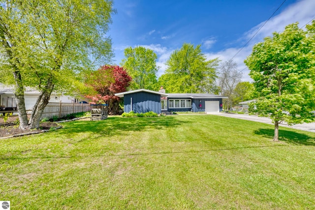 310 W Broadway, Suttons Bay, MI 49682 - view of front of home with an attached garage, driveway, and a chimney