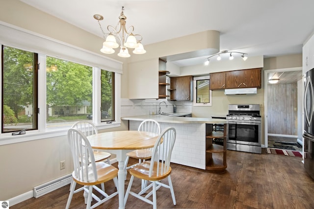 8695 S Maple City Rd, Maple City, MI 49664 - dining area featuring dark wood-type flooring, a baseboard heating unit, a chandelier, and baseboards