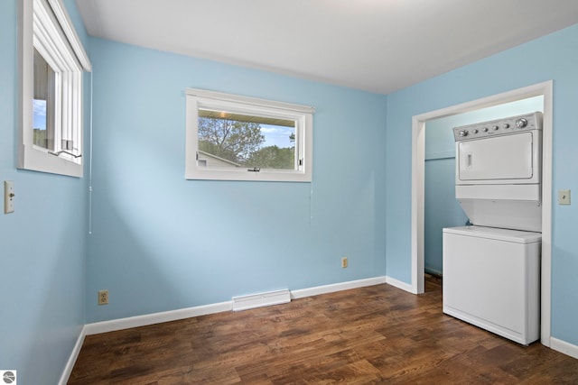 8695 S Maple City Rd, Maple City, MI 49664 - spare room with stacked washer / dryer, baseboards, and dark wood finished floors