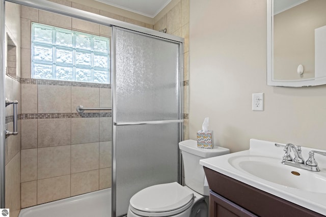 8695 S Maple City Rd, Maple City, MI 49664 - bathroom featuring toilet, a stall shower, vanity, and ornamental molding