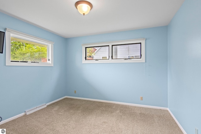 8695 S Maple City Rd, Maple City, MI 49664 - empty room featuring carpet flooring, baseboards, and baseboard heating