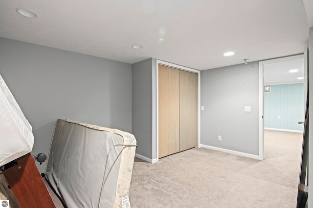 8695 S Maple City Rd, Maple City, MI 49664 - bedroom with baseboards, light carpet, recessed lighting, and a closet