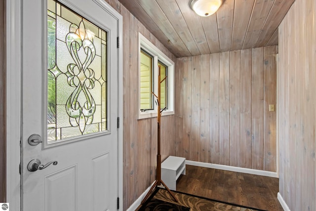 8695 S Maple City Rd, Maple City, MI 49664 - doorway to outside featuring baseboards, wood finished floors, wooden walls, and wood ceiling