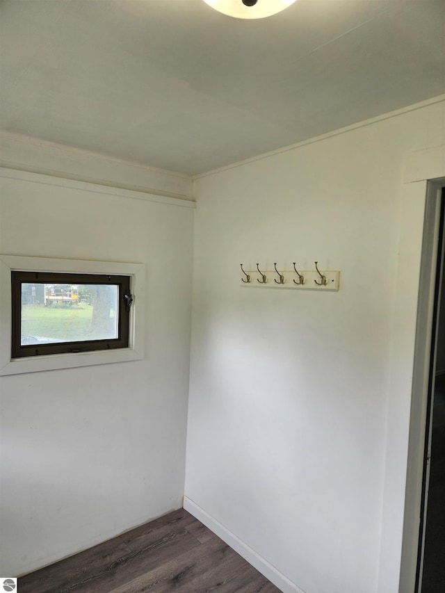 8540 W Monroe, Elwell, MI 48832 - unfurnished room featuring dark wood-type flooring and crown molding