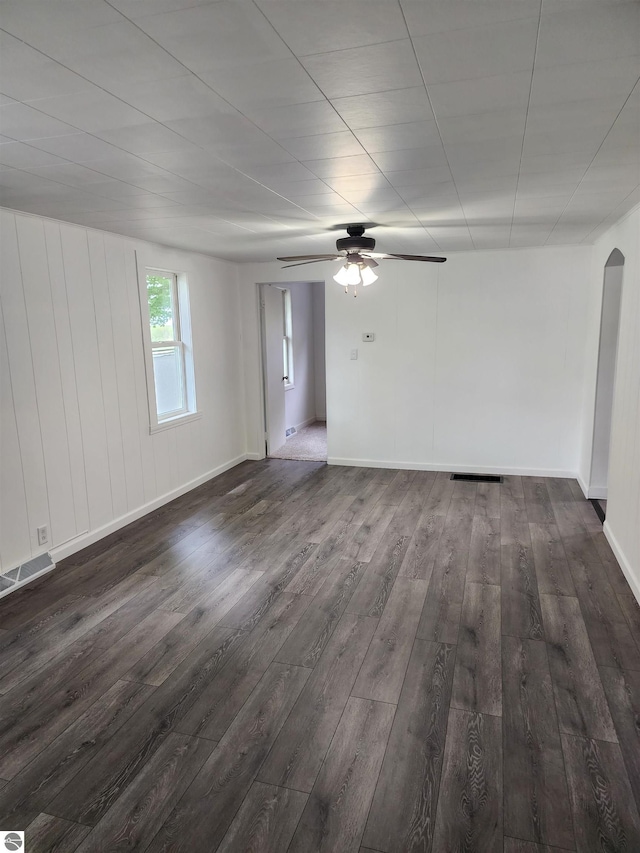 8540 W Monroe, Elwell, MI 48832 - spare room with dark wood finished floors, a ceiling fan, arched walkways, and baseboards