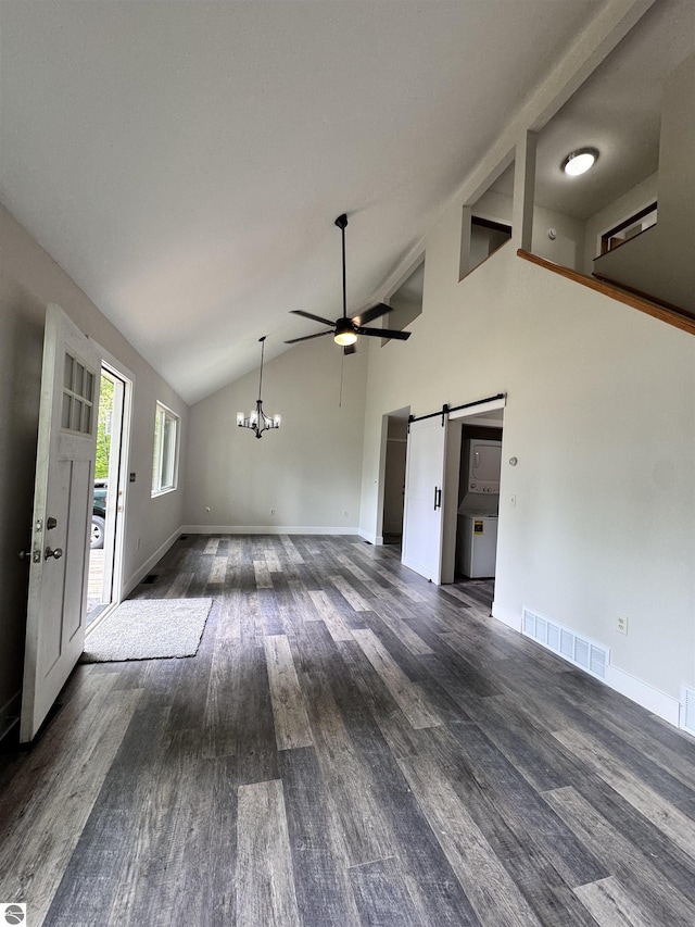 4872 E Shore Dr NE, Kalkaska, MI 49646 - unfurnished living room featuring a barn door, lofted ceiling, a ceiling fan, dark wood-style flooring, and baseboards
