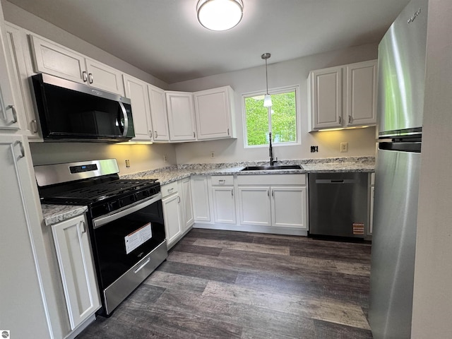 4872 E Shore Dr NE, Kalkaska, MI 49646 - kitchen featuring appliances with stainless steel finishes, a sink, white cabinets, and dark wood-style floors