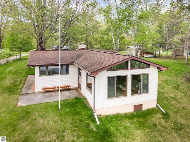 4645 Lakeview Dr, Hale, MI 48739 - view of front of property featuring roof with shingles, a chimney, a front lawn, and view of wooded area