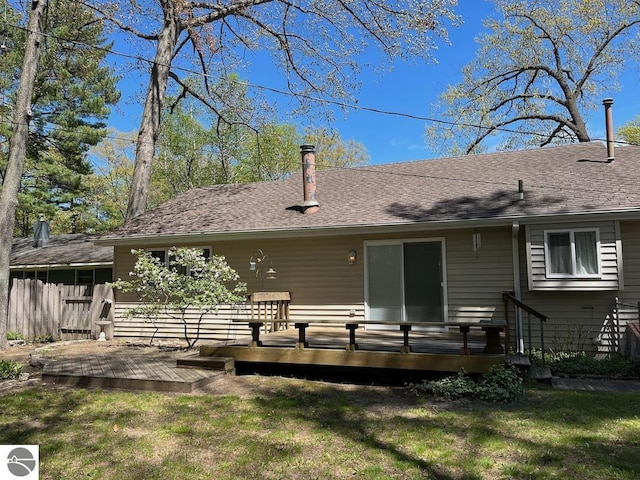 302 Huron St, Traverse City, MI 49686 - back of property featuring a deck, a chimney, and a shingled roof
