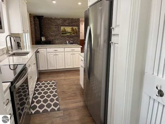 302 Huron St, Traverse City, MI 49686 - kitchen featuring freestanding refrigerator, range with electric cooktop, dark wood-style floors, white cabinets, and recessed lighting