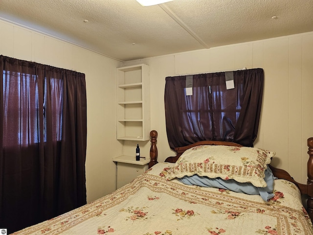 3058 Brodie Rd, South Branch, MI 48761 - bedroom with a decorative wall and a textured ceiling