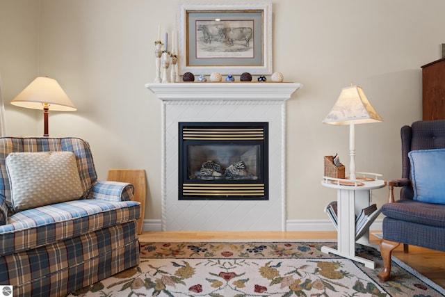 6200 Single Tree Ln, Williamsburg, MI 49690 - living room featuring baseboards, wood finished floors, and a glass covered fireplace