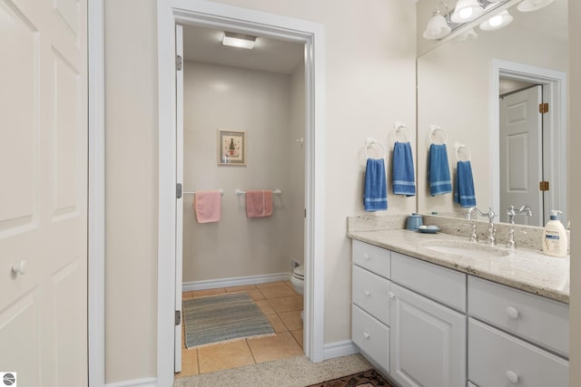 6200 Single Tree Ln, Williamsburg, MI 49690 - bathroom featuring vanity, toilet, baseboards, and tile patterned flooring