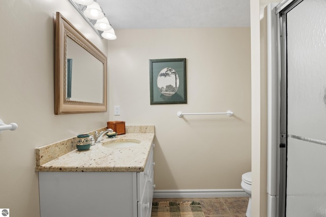 6200 Single Tree Ln, Williamsburg, MI 49690 - full bathroom featuring vanity, toilet, baseboards, and a shower with shower door