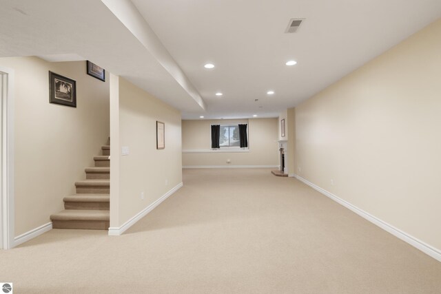 6200 Single Tree Ln, Williamsburg, MI 49690 - below grade area with recessed lighting, light colored carpet, baseboards, and stairway