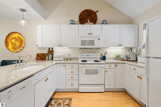 6200 Single Tree Ln, Williamsburg, MI 49690 - kitchen with white appliances, lofted ceiling, a sink, white cabinetry, and light stone countertops