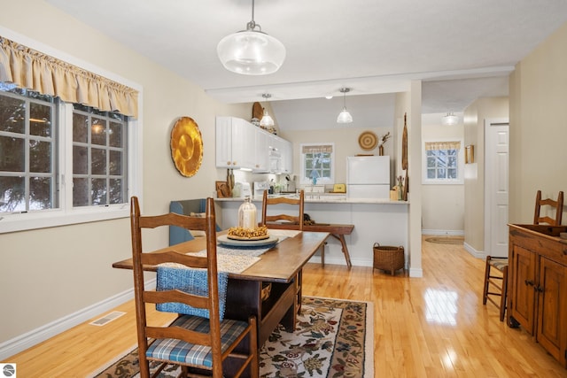 6200 Single Tree Ln, Williamsburg, MI 49690 - dining area featuring light wood-type flooring and baseboards