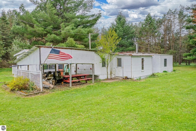 1151 N 8 Mile Rd, Lake City, MI 49651 - rear view of property featuring a yard