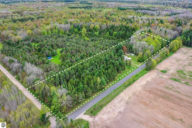 1151 N 8 Mile Rd, Lake City, MI 49651 - aerial view of property and surrounding area with a heavily wooded area and property boundaries highlighted