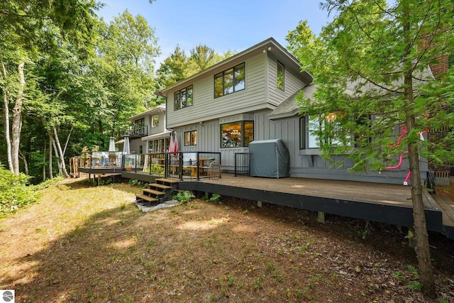 4283 Maitland Rd, Williamsburg, MI 49690 - back of property with board and batten siding and a wooden deck