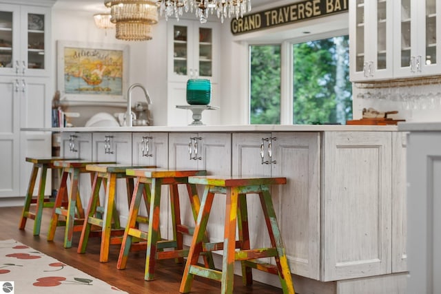4283 Maitland Rd, Williamsburg, MI 49690 - bar area with a chandelier and dark wood-style floors