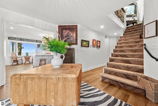 4283 Maitland Rd, Williamsburg, MI 49690 - staircase featuring baseboards, wood finished floors, recessed lighting, and a baseboard heating unit
