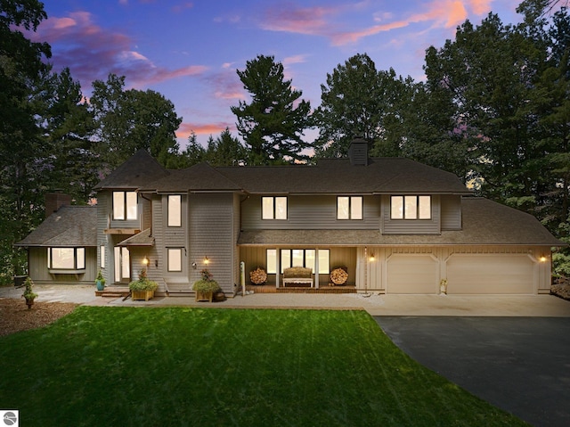 4283 Maitland Rd, Williamsburg, MI 49690 - view of front of home featuring asphalt driveway, a chimney, and a yard
