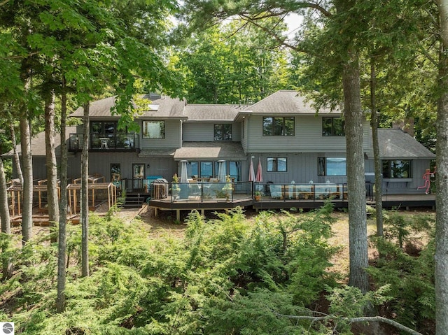 4283 Maitland Rd, Williamsburg, MI 49690 - back of property featuring a balcony, a shingled roof, and a deck