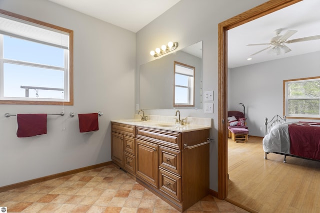 2769 White Rd, Frankfort, MI 49635 - ensuite bathroom with double vanity, baseboards, and ceiling fan
