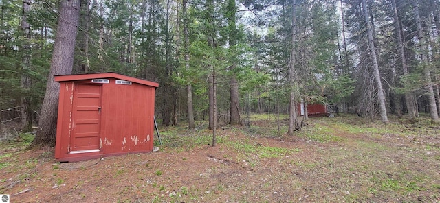 6031 Collins Rd, Onaway, MI 49765 - view of shed featuring a view of trees