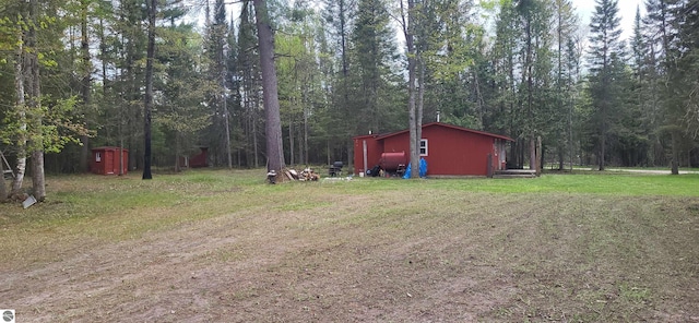 6031 Collins Rd, Onaway, MI 49765 - view of green lawn featuring a forest view