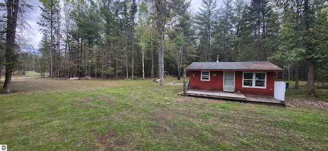 6031 Collins Rd, Onaway, MI 49765 - view of green lawn with an outdoor structure and a view of trees