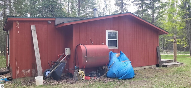 6031 Collins Rd, Onaway, MI 49765 - view of outdoor structure with view of wooded area and oil tank