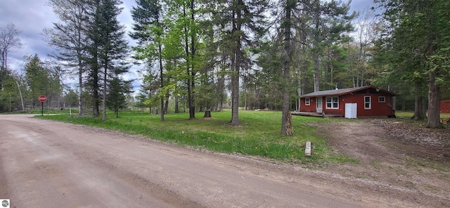 6031 Collins Rd, Onaway, MI 49765 - view of street with traffic signs and a forest view