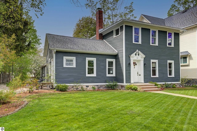 508 E State St, Traverse City, MI 49686 - view of front of property featuring a chimney, a front lawn, and roof with shingles