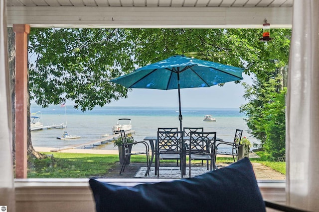 104 Haines Ave, Roscommon, MI 48653 - view of patio with a water view and outdoor dining space