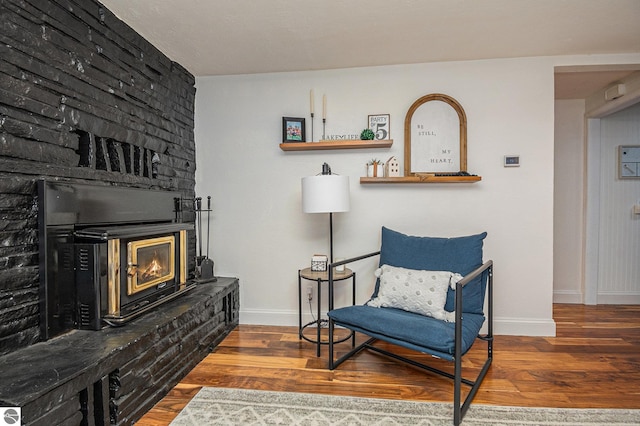 104 Haines Ave, Roscommon, MI 48653 - sitting room with a glass covered fireplace, baseboards, and wood finished floors