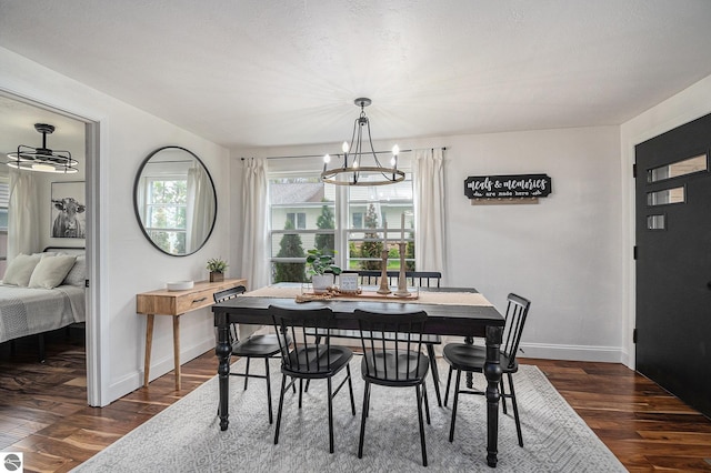 104 Haines Ave, Roscommon, MI 48653 - dining area featuring dark wood-style floors, a chandelier, and baseboards
