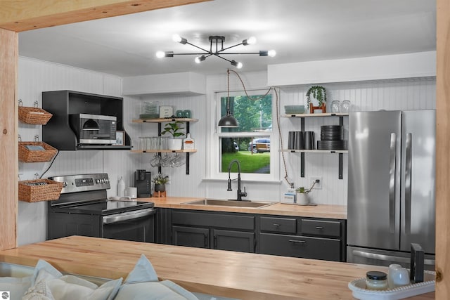 104 Haines Ave, Roscommon, MI 48653 - kitchen with appliances with stainless steel finishes, wood counters, a sink, and open shelves