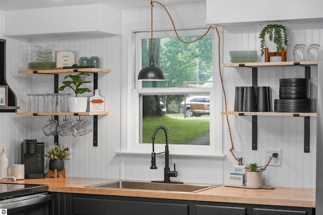 104 Haines Ave, Roscommon, MI 48653 - kitchen with open shelves, butcher block countertops, a sink, and dark cabinets