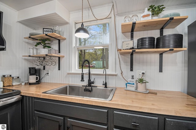 104 Haines Ave, Roscommon, MI 48653 - kitchen featuring butcher block countertops, a sink, open shelves, and dark cabinetry