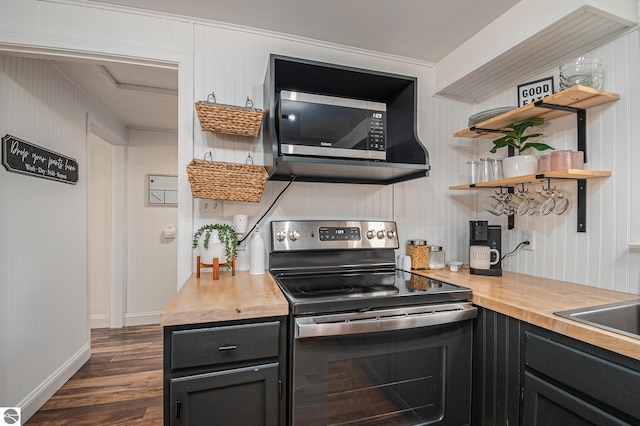 104 Haines Ave, Roscommon, MI 48653 - kitchen featuring appliances with stainless steel finishes, butcher block countertops, dark wood-style floors, and baseboards
