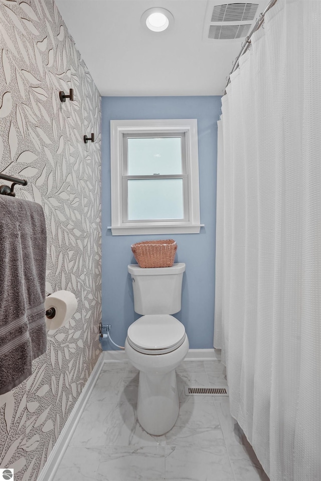 104 Haines Ave, Roscommon, MI 48653 - bathroom with baseboards, toilet, marble finish flooring, and a shower with shower curtain