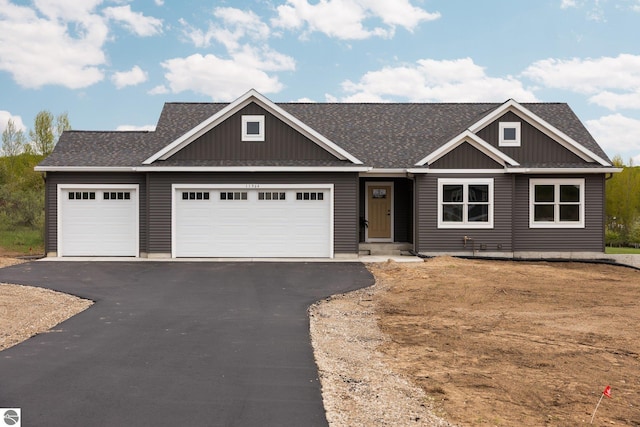 11964 E Shaker Trl, Suttons Bay, MI 49682 - craftsman-style home with an attached garage, asphalt driveway, and a shingled roof
