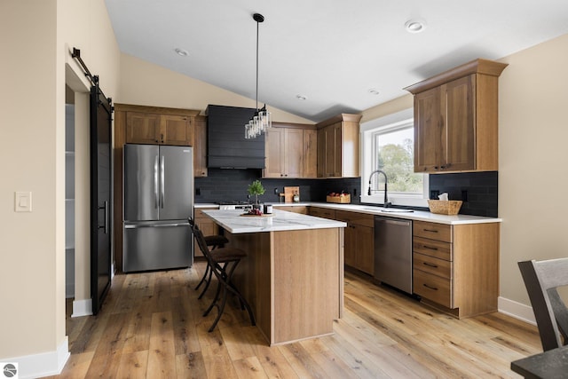 11964 E Shaker Trl, Suttons Bay, MI 49682 - kitchen with appliances with stainless steel finishes, a sink, lofted ceiling, a kitchen island, and backsplash