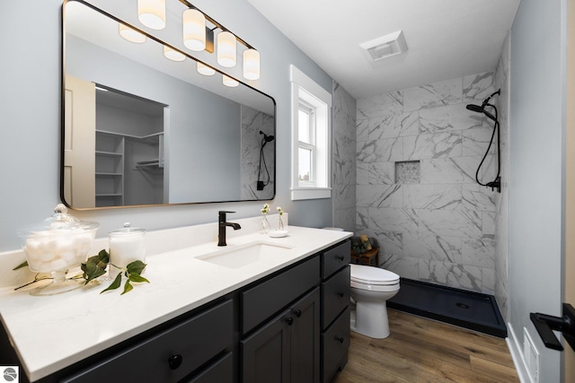 11964 E Shaker Trl, Suttons Bay, MI 49682 - full bathroom with vanity, a shower stall, wood finished floors, and toilet