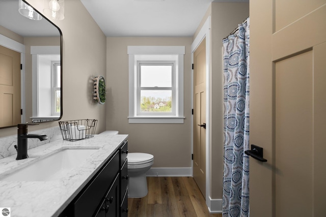 11964 E Shaker Trl, Suttons Bay, MI 49682 - full bath featuring vanity, toilet, wood finished floors, baseboards, and a shower with shower curtain