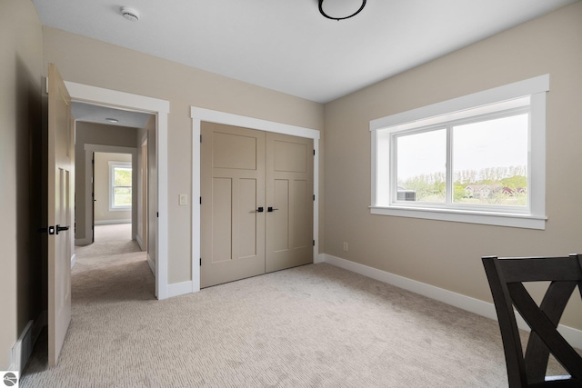 11964 E Shaker Trl, Suttons Bay, MI 49682 - unfurnished bedroom featuring light carpet, baseboards, and a closet
