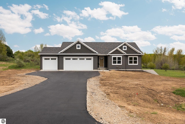 11964 E Shaker Trl, Suttons Bay, MI 49682 - craftsman inspired home featuring a garage and asphalt driveway