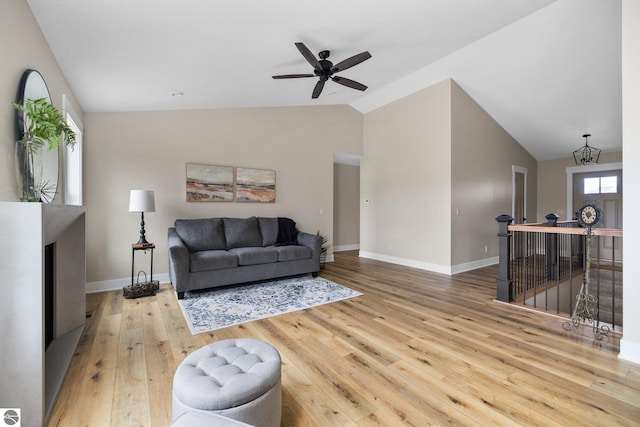 11964 E Shaker Trl, Suttons Bay, MI 49682 - living area with vaulted ceiling, wood-type flooring, baseboards, and a ceiling fan